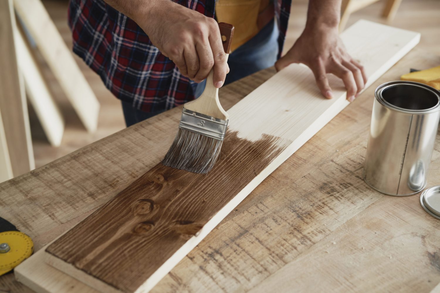 Detail of painting the raw board with a stain